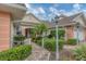 Beautiful villa with brick walkway, lush landscaping, mature palm, and attached garage at 2028 Lynx Run, North Port, FL 34288