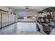 Spacious garage with storage cabinets and a golf cart at 2028 Lynx Run, North Port, FL 34288