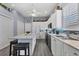 The charming kitchen features white cabinetry, an island with seating, and views of the adjacent dining area at 2028 Lynx Run, North Port, FL 34288
