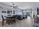 Open-concept living area with wood-look flooring, ceiling fans, and views into the screened lanai at 2028 Lynx Run, North Port, FL 34288
