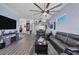 Spacious living area with wood floors, comfortable seating, and an open layout to the kitchen at 2028 Lynx Run, North Port, FL 34288