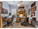 Comfortable home office with wood floors, ceiling fan and plenty of motorcycle decor at 2028 Lynx Run, North Port, FL 34288