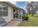 Exterior view of a screened-in patio with outdoor seating at 2028 Lynx Run, North Port, FL 34288