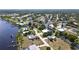 Aerial view of a waterfront home with canal access and lush greenery in a residential neighborhood at 2028 River Basin Ter, Punta Gorda, FL 33982