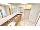Bathroom with dual sinks, granite countertop, and ample closet space at 2028 River Basin Ter, Punta Gorda, FL 33982