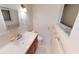 Bathroom features a vanity with a white sink and neutral tiles at 2028 River Basin Ter, Punta Gorda, FL 33982