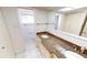Bright bathroom with dual sinks, granite countertops, and tiled floor at 2028 River Basin Ter, Punta Gorda, FL 33982