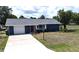 Charming single-story home with a well-maintained lawn, paved driveway, and attached garage at 2028 River Basin Ter, Punta Gorda, FL 33982