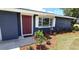 Inviting entryway with a red door, manicured landscaping, and a bright window at 2028 River Basin Ter, Punta Gorda, FL 33982