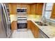 Modern kitchen with stainless steel appliances, granite countertops, and ample cabinet space at 2028 River Basin Ter, Punta Gorda, FL 33982