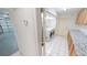 A laundry room with a washer, dryer, white tile floors, and cabinets with granite countertops at 2028 River Basin Ter, Punta Gorda, FL 33982