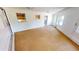 Sun-lit living room features neutral carpet and a doorway to the kitchen at 2028 River Basin Ter, Punta Gorda, FL 33982