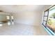 Bright living room featuring tile floors, ceiling fans, and natural light from large windows at 2028 River Basin Ter, Punta Gorda, FL 33982