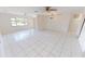 Large, bright living room showcasing tile floors, ceiling fans, and ample space for entertaining at 2028 River Basin Ter, Punta Gorda, FL 33982