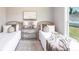 Cozy bedroom with twin beds, decorative rug, and a sunlit window view at 221 Dorman St, Port Charlotte, FL 33953