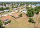 An aerial view of a home on a large lot with mature trees near a lake at 2365 Nuremberg Blvd, Punta Gorda, FL 33983
