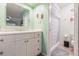 Fresh bathroom featuring white vanity, large mirror, and shower with decorative shower curtain at 2365 Nuremberg Blvd, Punta Gorda, FL 33983