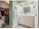 Bathroom showing white vanity with closet and shower, decorated with matching towels at 2365 Nuremberg Blvd, Punta Gorda, FL 33983