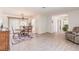 Bright dining area with hardwood floors, a chandelier, and an adjacent living area at 2365 Nuremberg Blvd, Punta Gorda, FL 33983
