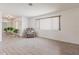 Cozy living room features light wood floors, a comfortable chair and a window with blinds at 2365 Nuremberg Blvd, Punta Gorda, FL 33983