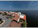 Waterfront home with red tile roof, brick driveway, and lush landscaping offers beautiful water views at 25188 Marion Ave # 1, Punta Gorda, FL 33950
