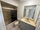 Bathroom featuring a shower with glass doors, a vanity with a sink, and a mirror at 25188 Marion Ave # 1, Punta Gorda, FL 33950