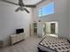 Bedroom featuring tile flooring, a ceiling fan, and an elevated window allowing ample natural light at 25188 Marion Ave # 1, Punta Gorda, FL 33950