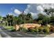 Elegant Emerald Pointe community entrance sign surrounded by lush tropical landscaping and colorful flowers at 25188 Marion Ave # 1, Punta Gorda, FL 33950