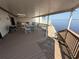 Wide, covered deck with outdoor seating and railings overlooking the water, creating a relaxing outdoor space at 25188 Marion Ave # 1, Punta Gorda, FL 33950