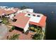 Waterfront home has a red tile roof, two-car garage, and an inviting outdoor patio overlooking the water at 25188 Marion Ave # 1, Punta Gorda, FL 33950