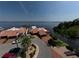 Waterfront home features a charming red tile roof, lush landscaping, and brick-paved drive, with stunning views of the bay at 25188 Marion Ave # 1, Punta Gorda, FL 33950