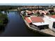Waterfront community featuring homes with red tile roofs, a private waterway, mature landscaping, and private docks at 25188 Marion Ave # 1, Punta Gorda, FL 33950