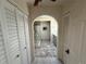 Hallway with neutral colors leading to the bathroom featuring a skylight and closet space at 25188 Marion Ave # 1, Punta Gorda, FL 33950