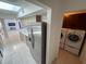 View of kitchen with stainless steel appliances and direct access to the laundry room at 25188 Marion Ave # 1, Punta Gorda, FL 33950