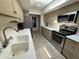 Kitchen featuring stainless steel appliances, white countertops, and a skylight for natural light at 25188 Marion Ave # 1, Punta Gorda, FL 33950