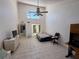 Bright living area featuring tile flooring, a ceiling fan, and a large window allowing natural light at 25188 Marion Ave # 1, Punta Gorda, FL 33950