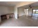 Spacious living room with tile flooring, a ceiling fan, and access to a balcony at 25188 Marion Ave # 1, Punta Gorda, FL 33950