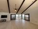Spacious living room with tile floors and sliding glass doors that open to a waterfront balcony at 25188 Marion Ave # 1, Punta Gorda, FL 33950