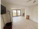 Bright living room featuring tile floors, a ceiling fan, and sliding glass doors to a covered balcony at 25188 Marion Ave # 1, Punta Gorda, FL 33950