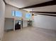 Open floor plan shows the kitchen, living room, and dining area with beamed ceilings and neutral colors at 25188 Marion Ave # 1, Punta Gorda, FL 33950
