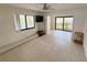 Bright living area featuring tile flooring, lots of natural light, and access to the balcony at 25188 Marion Ave # 1, Punta Gorda, FL 33950