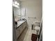 The bathroom has a single sink vanity, toilet and large mirror at 2696 Gisela Rd, North Port, FL 34287