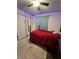Cozy bedroom featuring a red bedspread, plush rug, and decorative LED lighting at 2696 Gisela Rd, North Port, FL 34287