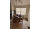 Cozy dining area with wooden chairs, a round table, and natural light from the window at 2696 Gisela Rd, North Port, FL 34287