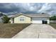 Charming single-story home with attached garage, neat landscaping, and inviting curb appeal at 2696 Gisela Rd, North Port, FL 34287