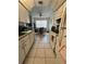 Functional kitchen featuring white appliances, tile flooring, and adjacent dining area at 2696 Gisela Rd, North Port, FL 34287