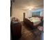 A spacious main bedroom with hardwood floors, a ceiling fan and a sliding glass door at 2696 Gisela Rd, North Port, FL 34287
