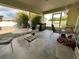 Enclosed patio featuring outdoor seating, a barbecue grill, and views of lush greenery at 2696 Gisela Rd, North Port, FL 34287