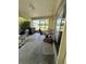 Relaxing enclosed patio with outdoor seating, a grill, and serene views of the yard at 2696 Gisela Rd, North Port, FL 34287