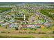 An aerial view showcases the home's location within a tranquil neighborhood with serene ponds and lush green spaces at 2747 Suncoast Lakes Blvd, Punta Gorda, FL 33980